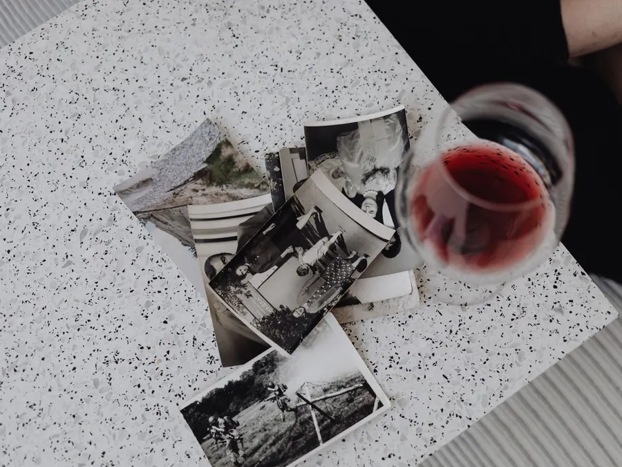 Vintage black and white family photographs laid out together on a table